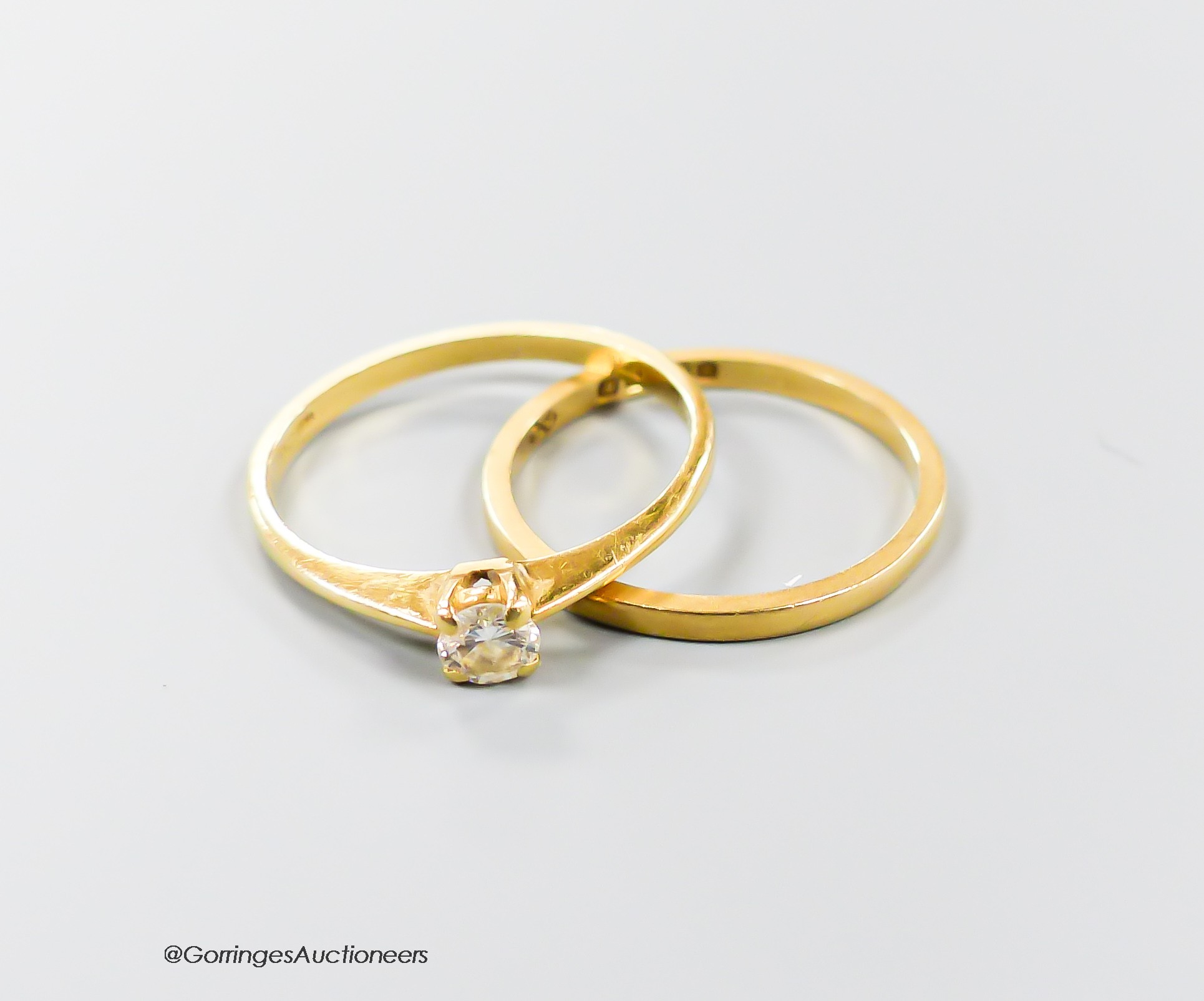 An 18kt and solitaire diamond ring and an 18ct gold wedding band, gross 2.5 grams.